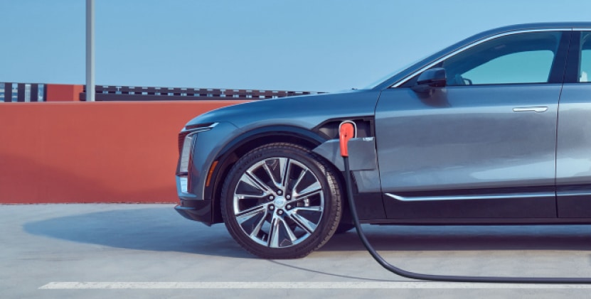 Electric car charging at a station, showcasing eco-friendly transportation and modern vehicle design.