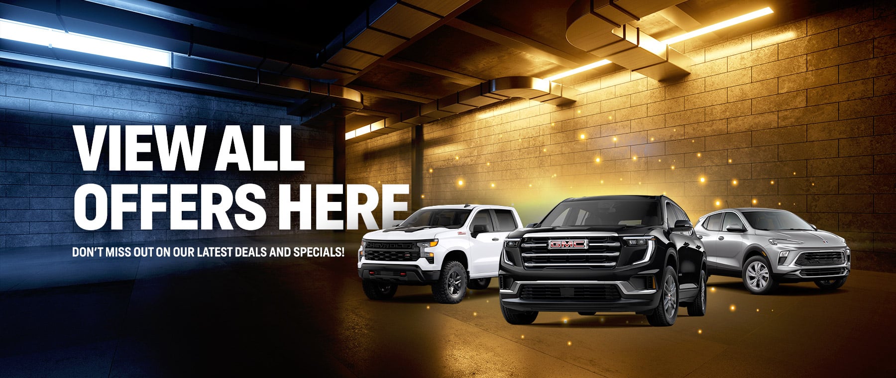 Cars displayed in a lit, urban parking lot with text: "View All Offers Here. Don't miss our latest deals."