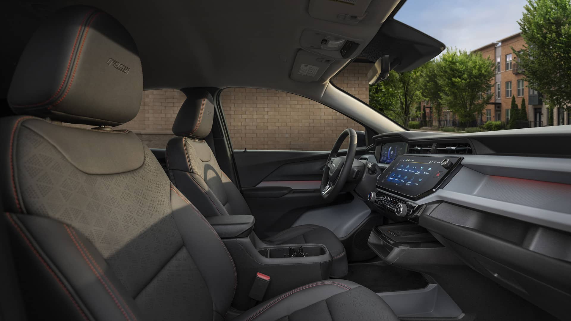 Modern car interior with black seats, a digital dashboard, and detailed red stitching.