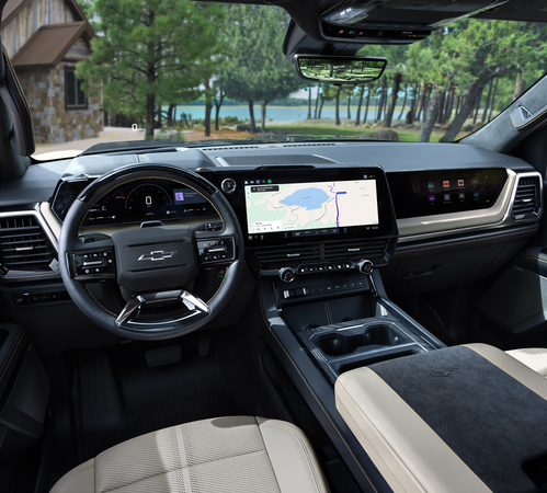 Modern SUV interior with leather seats, digital dashboard, and advanced navigation screen near a scenic lake view.