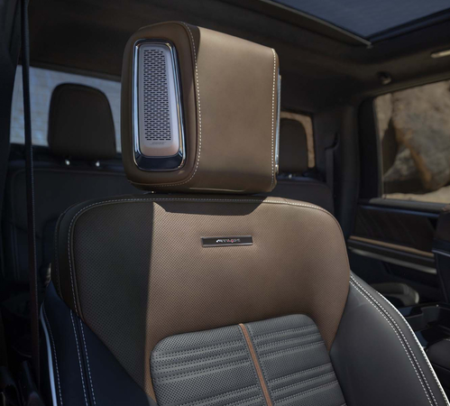 Luxury car interior featuring a stylish two-tone leather seat with textured patterns and sleek design.